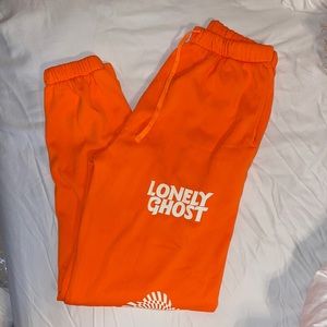 Bright orange LONELY GHOST sweatpants